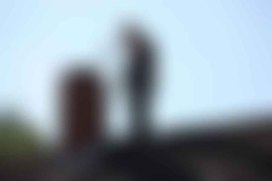 Professional chimney cleaner inspecting a chimney